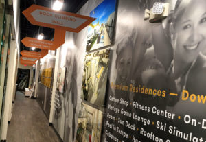 Retail wall graphics advertising various things in a hall.