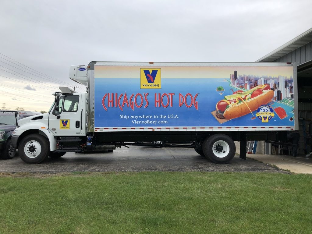 Vienna Beef truck wrap featuring iconic logo and Chicago-style hot dog, vibrant colors and bold text.