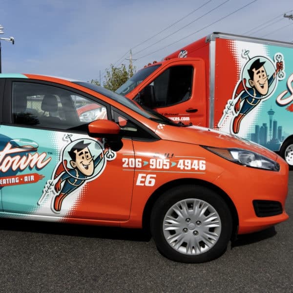 Red and aqua green car with cartoon character on the side, displaying 'Seatown' text.