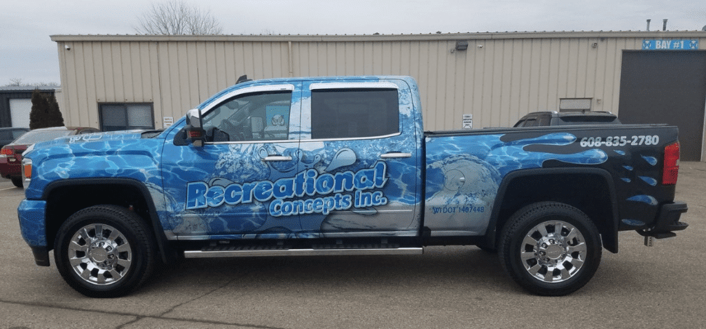 A vehicle car wrap with a blue and white design on it, featuring a blue car wrap.