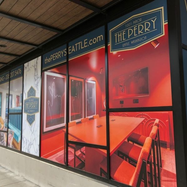 A restaurant's wall wrap displayed in a large window, showcasing a captivating picture.