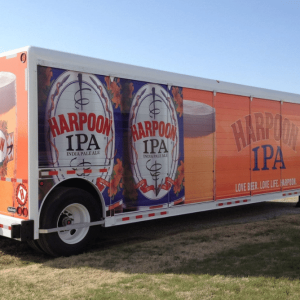 A trailer with 'Harpoon IPA' text on the side, showcasing beer.