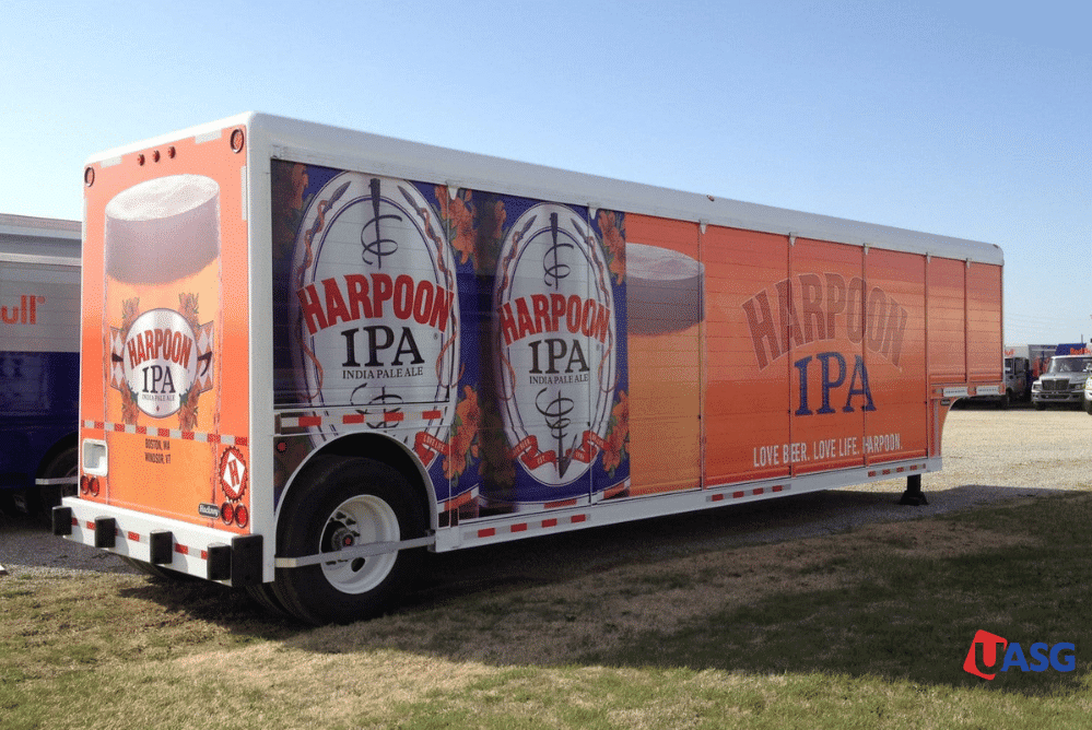 A trailer with 'Harpoon IPA' text on the side, showcasing beer.