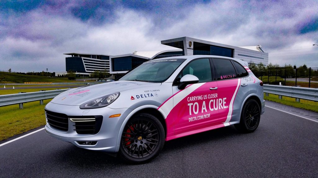 An image of a Porsche SUV on the road.