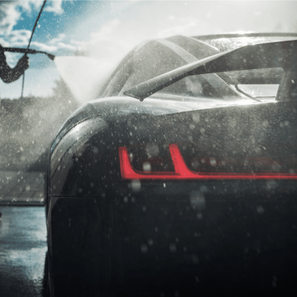 An image of a man man diligently washes his car.