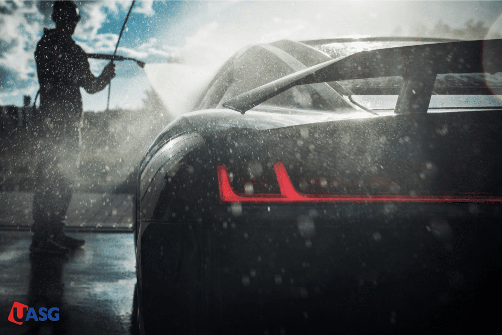 An image of a man man diligently washes his car.