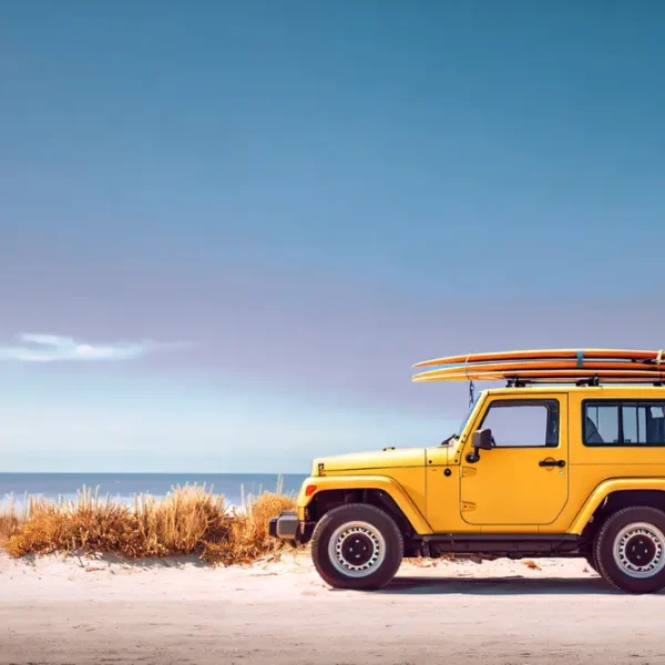 A yellow jeep with a surfboard on top, showcasing a vibrant outdoor lifestyle and customizable vehicle wrap.